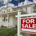 Polis Insurance Claim Shocks Colorado A suburban house with a For Sale sign in the front yard