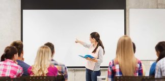 Principal’s Shocking Exit: Protecting Kids or Themselves? A teacher presenting to students in a classroom