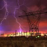 Sky Bomb Jolts New England Lightning strikes illuminate a power station against a colorful sunset sky