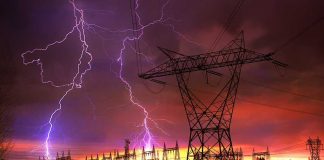 Sky Bomb Jolts New England Lightning strikes illuminate a power station against a colorful sunset sky