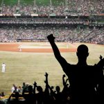 Foul Ball Horror: Fan Rushed to ER! Crowd of fans cheering at a baseball game in a stadium