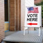 Map Wars Backfire — California’s TWIST Vote Here sign with arrow and American flag.