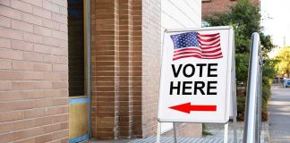 Map Wars Backfire — California’s TWIST Vote Here sign with arrow and American flag.