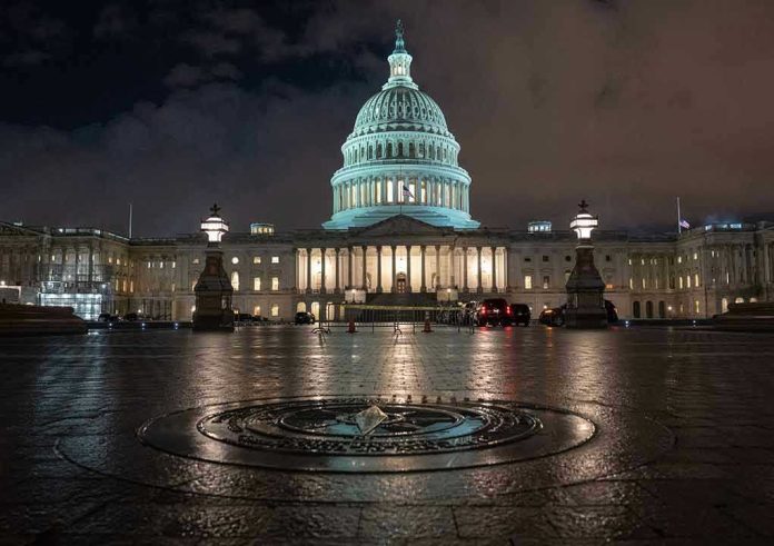 1264598587-1 U.S. Capitol building illuminated at night with wet pavement.