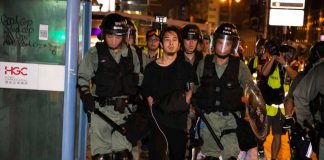 Mass Arrest BLITZ — 6,500 VANISH Overnight Police arresting a person during a nighttime protest