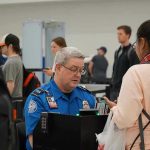 TSA Uncovers LIVE Bomb — UNEXPECTED TWIST TSA agent checks passengers documents at airport security.