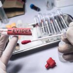 BEYOND COMPREHENSION — DNA Scandal SHREDS a THOUSAND Cases Gloved hands holding evidence tube and cotton swab.