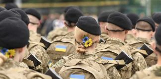 WITCHES Of Bucha — What THEY DO Soldiers in camouflage uniforms with Ukrainian flags.