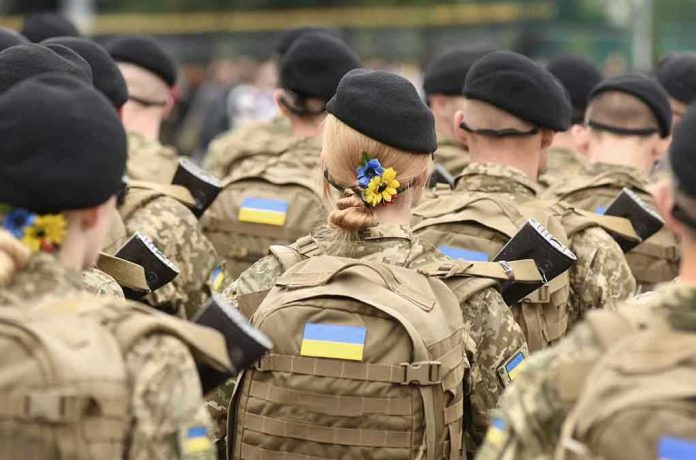 2029545419 Soldiers in camouflage uniforms with Ukrainian flags.