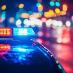 VICIOUS Bar Brawl IGNITES Racial Firestorm Police car with flashing lights at night.