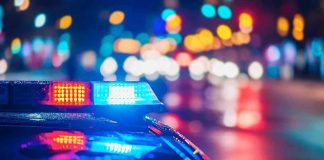 VICIOUS Bar Brawl IGNITES Racial Firestorm Police car with flashing lights at night.