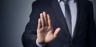 SCOTUS BOMBSHELL — Judge THOMAS Issues CHILLING WARNING Man in suit with hand raised, signaling stop.