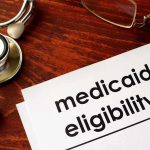 Operation Skip Trace SNAGS Ringleaders — FINALLY! Stethoscope pen document about Medicaid eligibility on table