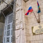 Moscow’s DOUBLE Game FINALLY EXPOSED Russian ministry building entrance with ornate metal door and flags