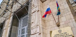 Moscow’s DOUBLE Game FINALLY EXPOSED Russian ministry building entrance with ornate metal door and flags