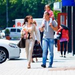 FAMILY OUTING Becomes War Zone — Many SHOT! A family walking on a sidewalk in an urban area, with a child on the fathers shoulders
