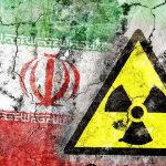 Trump’s ‘Great Deal’—Or Nuclear Mirage? A cracked wall featuring the Iranian flag and a nuclear warning symbol