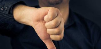 OUSTED President is CRYING FOUL — Look WHO He’s Blaming! Hand showing thumbs down gesture, dark background.