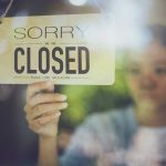 BELOVED Park Shuts Down — ACCUSATIONS are FLYING Hand hanging a closed sign on a shop door
