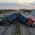 Freeway BLOODBATH — MASS Casualties — Details UNEARTHED Two overturned trucks blocking a highway with emergency responders at the scene