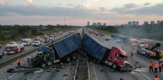 Freeway BLOODBATH — MASS Casualties — Details UNEARTHED Two overturned trucks blocking a highway with emergency responders at the scene