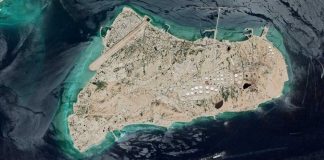 What Trump is EYEING NOW — When CONTROL is CRITICAL — JUST BUY IT! Aerial view of an industrial island with tanks, runway, and piers