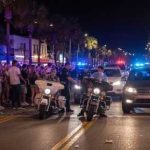 TERRIFYING — MANY DOWN In UNEXPECTED Street MAYHEM Police officers managing a crowd on a busy street at night