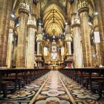 Michigan BOMBSHELL Names 22 Clergy — NO Charges! Interior of a grand cathedral with empty pews.