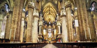 Michigan BOMBSHELL Names 22 Clergy — NO Charges! Interior of a grand cathedral with empty pews.