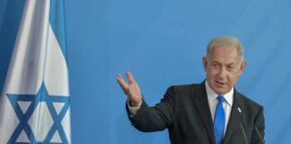 DANGEROUS Gamble — Israel Picks A PRINCE? Man in suit gestures beside Israeli flag.