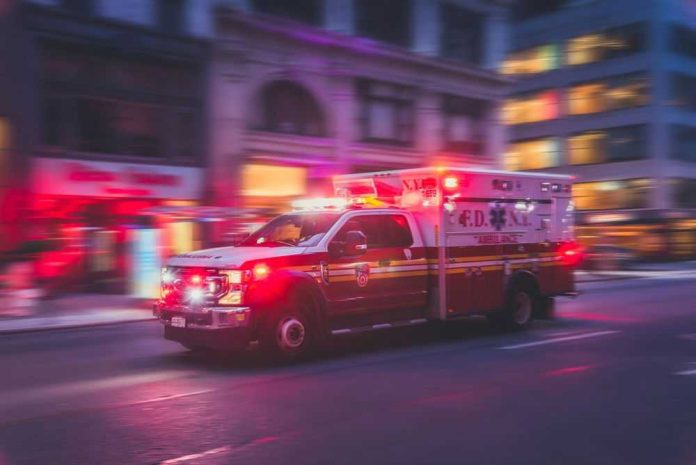 Ambulance speeding with flashing lights in city street