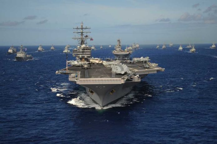aircraft-carrier_2599523537 Aircraft carrier leads a naval fleet at sea