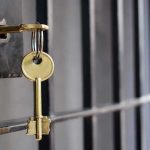 Backroom CALL FREES Pastor — What Got TRADED? Golden key hanging from a lock on a metal jail cell door