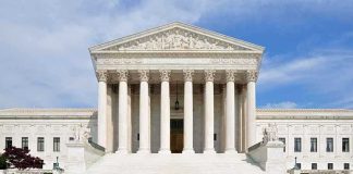 NEW Birthright Bombshell — Congress DEFIES Supreme Court! Front view of the Supreme Court building with large columns and steps under a blue sky