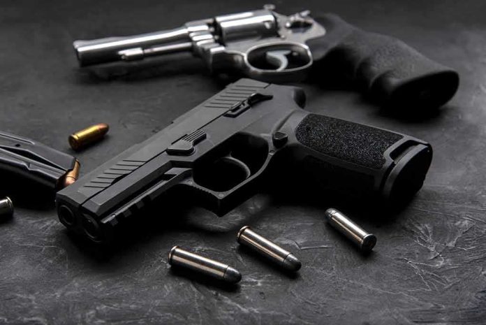 Handgun and revolver with scattered bullets on dark surface