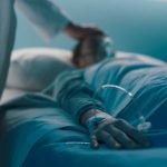 Shocking ASSISTED SUICIDE ERRORS — More Than HALF! A medical professional attending to a patient in a hospital bed