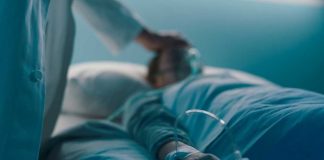 Shocking ASSISTED SUICIDE ERRORS — More Than HALF! A medical professional attending to a patient in a hospital bed