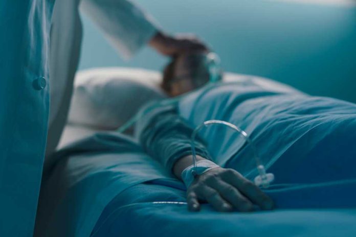shutterstock_1667219626 A medical professional attending to a patient in a hospital bed