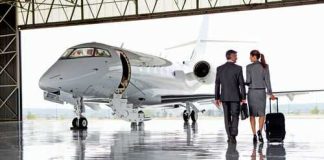 Oligarch Cash VANISHES — BILLIONS! Two businesspeople walking towards a private jet in hangar.