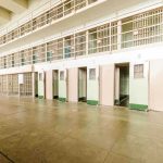 Elderly Bishop SNATCHED — No Warrant, No Why Interior view of a prison cell block with empty cells and security bars