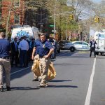 RANTING Rhetoric Sparks Knifings, City BOILS Police officers and investigators at a blocked city street scene