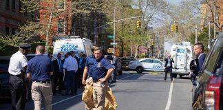 RANTING Rhetoric Sparks Knifings, City BOILS Police officers and investigators at a blocked city street scene