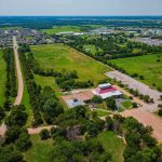 They Want to Build WHAT?? — WHERE?? Aerial view of rural landscape with roads, fields, and scattered buildings
