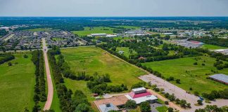 They Want to Build WHAT?? — WHERE?? Aerial view of rural landscape with roads, fields, and scattered buildings