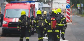 DEADLY House Inferno Hides Something MUCH MUCH Worse Firefighters walking toward a scene with hoses and a red emergency van