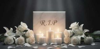 SUDDEN SHOCKING Death Ends MUSIC ICON’S LIFE A memorial display featuring candles and white roses with a marble stone inscribed 'R.I.P.'