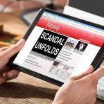 Missing Kids SCANDAL Engulfs Former HHS TOP BOSS Hands holding a tablet showing an online news website