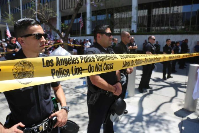 shutterstock_634192238 Los Angeles police officers standing behind a police line