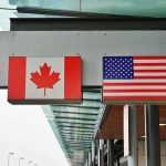 Trump Revives 1930 HAMMER — Canada JOLTED Canadian and American flags displayed at a border crossing