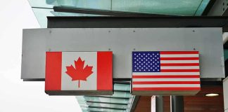 Trump Revives 1930 HAMMER — Canada JOLTED Canadian and American flags displayed at a border crossing